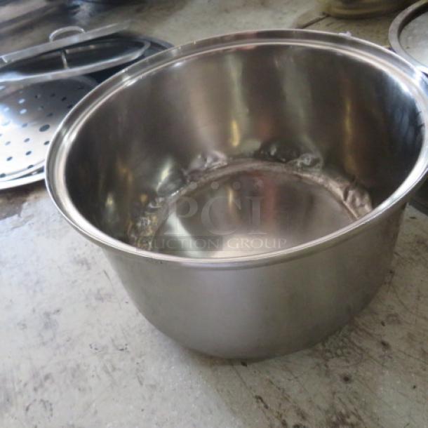 Stainless steel stock pot, size 12.5x8 inches, in good condition. Features sturdy construction, ideal for cooking.