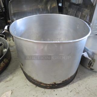 Aluminum stock pot, 20x15 inches, used condition with visible wear on the base, ideal for commercial cooking.