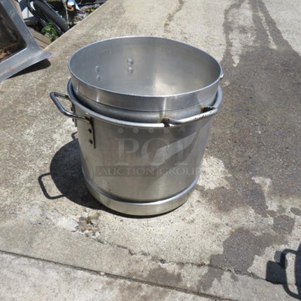 Aluminum Stock Pot 2XBID, large capacity, with side handles. Used condition with visible wear. Ideal for commercial use.