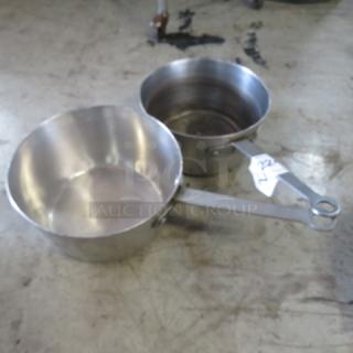 9-inch metal sauce pan in good condition, with attached tag labeled "2XBID". Sturdy handles, lightly worn surface.