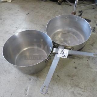 Two 12-inch aluminum saucepans with long handles, showing signs of wear. Label "225" attached to one handle.