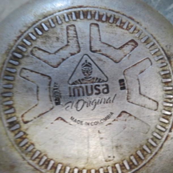 Imusa Original sauce pan base with logo and "Made in Colombia" marking, showing moderate wear.