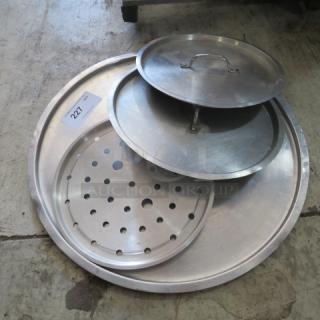 Assorted metal lids, including perforated and solid designs, in good condition. Label visible: "227."