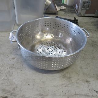 15-inch aluminum colander with perforated body and dual handles, in good condition, ideal for straining tasks.