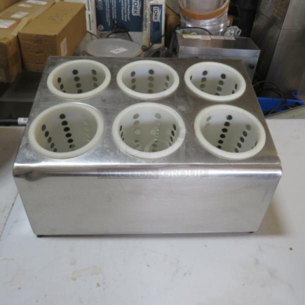 Stainless steel flatware holder with six perforated compartments, used condition, ideal for kitchen organization.