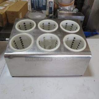 Stainless steel flatware holder with six perforated compartments, used condition, ideal for kitchen organization.