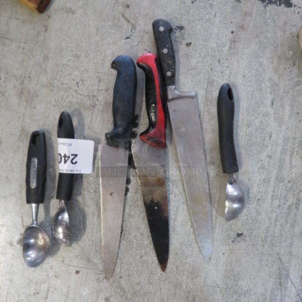 Assorted kitchen utensils including knives and scoops, featuring black and red handles, varying conditions. Tag marked "240".