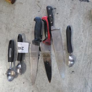 Assorted kitchen utensils including knives and scoops, featuring black and red handles, varying conditions. Tag marked "240".