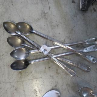 Six stainless steel spoons, elongated handles, used condition, tagged with number "249", model 5XBID.