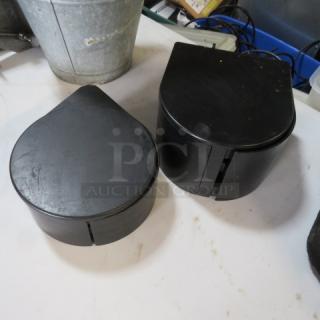 Black Margarita Salter containers, teardrop-shaped, set of two, appear gently used, ideal for spice storage or décor.