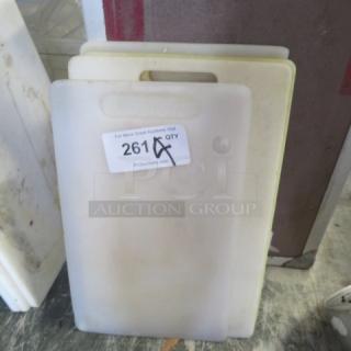 Assorted cutting boards, pre-owned, varying sizes, white and yellow, visible label: "261 QTY."