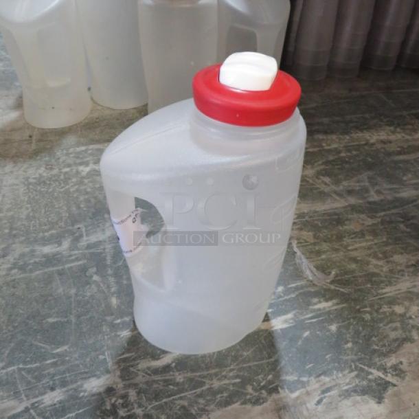 Poly measurer with red lid and white spout. Made of translucent plastic with handle. Model 6XBID. Good condition.