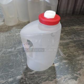Poly measurer with red lid and white spout. Made of translucent plastic with handle. Model 6XBID. Good condition.