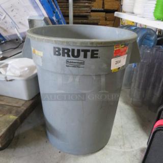 Rubbermaid Brute trash can, gray, industrial-grade, visible brand logo and labels, in good condition.