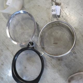 Three mesh strainers with metal and plastic rims, varying sizes, in good condition. Visible tag indicates lot number 107.