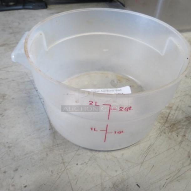 Translucent 2-quart food storage container with red measurement markings; used condition with visible wear.