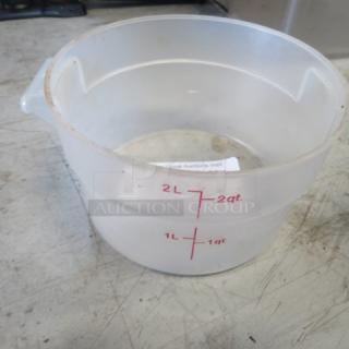 Translucent 2-quart food storage container with red measurement markings; used condition with visible wear.