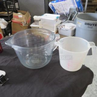 Assorted measuring cups; glass and plastic with handles. Visible markings for measurements. Used condition.