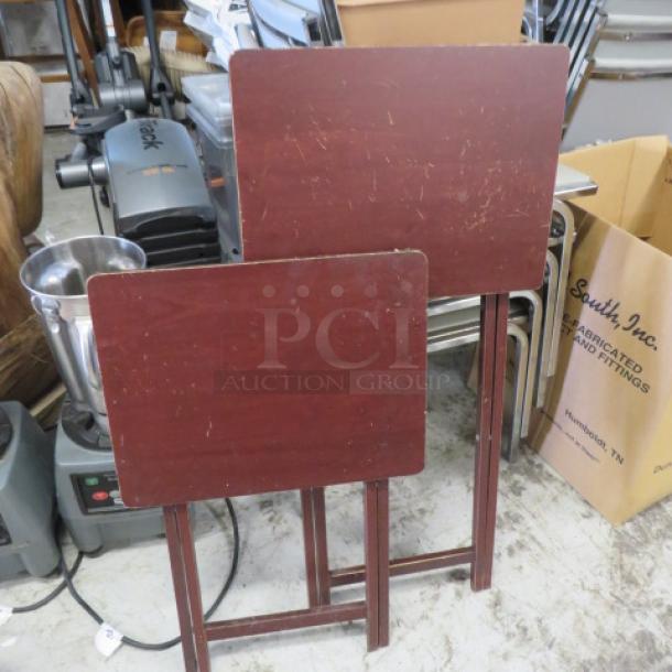 Wooden tray tables, set of two, with a rich brown finish. Light scratches visible, foldable design for easy storage.