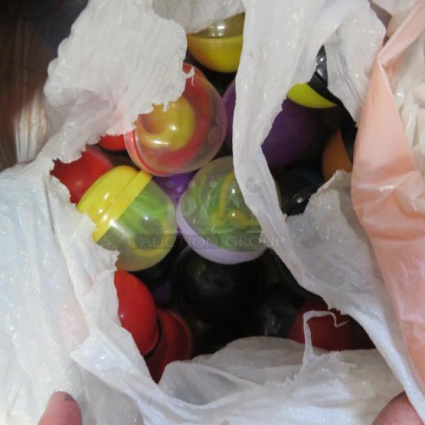 Bag filled with colorful plastic capsules containing vending machine prizes.