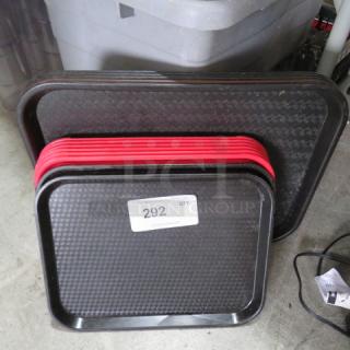 Assorted lunch trays in black and red, stacked. Includes textured surfaces. Marked with lot number 292 for auction.