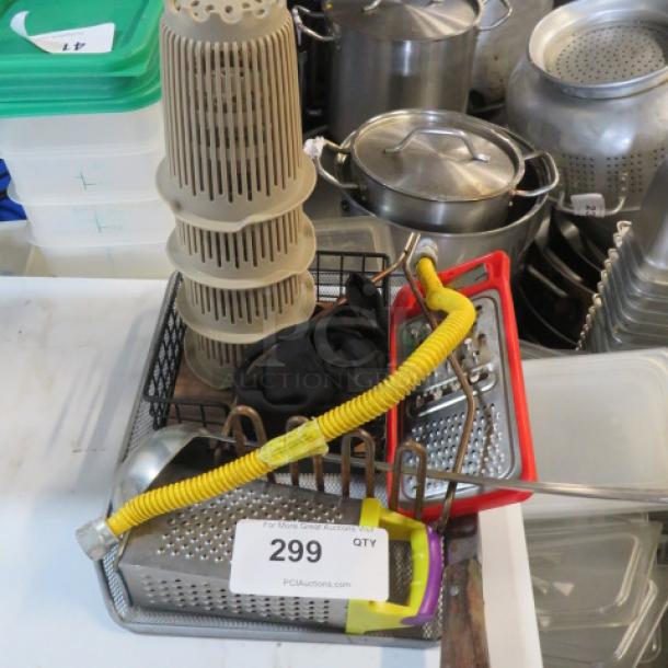 A lot of miscellaneous kitchen items including a grater, yellow hose, stackable strainers, and metal pots, tagged with number 299.