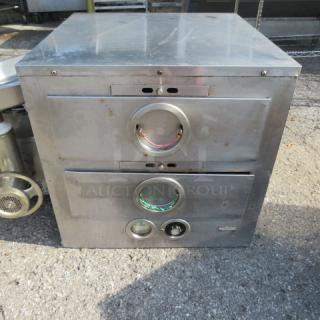 Stainless steel 2-drawer warmer, dimensions 24"x23"x22.5", showing front view. Visible minor wear, circular control indicators.