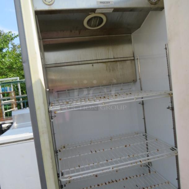 Kelvinator Commercial Freezer KFS220RHY2 with 4 racks, 32x31x74.5 inches, on casters. Visible wear inside. 115 Volt.