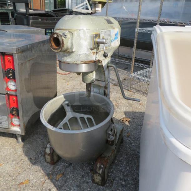 Hobart A-200 mixer with bowl and paddle, used condition. Features include a silver finish and heavy-duty build.