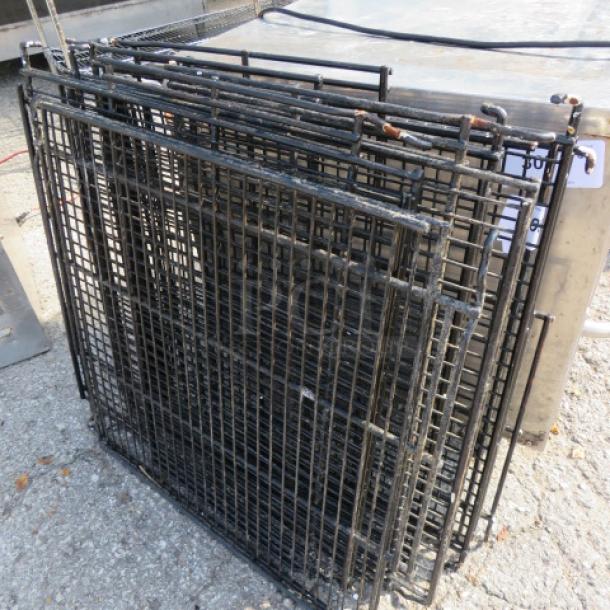 Assorted metal racks, black, stacked. Dimensions 26.5x24 inches. Used condition; suitable for storage or shelving.