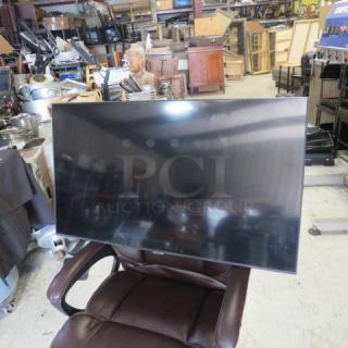 Vizio 40-inch Smart TV, Model V4045 H19, in used condition, displayed on a chair in a workshop setting.