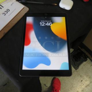 Alt text: One iPad #A2602 with colorful screen, excellent condition, displayed on a black surface.