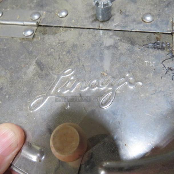 Vintage Lindys Popcorn Popper with embossed logo, metal construction, hinged lid, good condition with visible wear.
