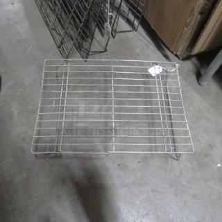 One lot of 19 metal cooling racks, various sizes, stackable design, used condition, suitable for commercial kitchens.