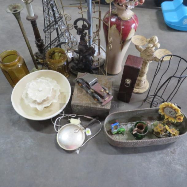 A collection of miscellaneous items including vases, candlesticks, a decorative bowl, and various antique-inspired decor pieces.