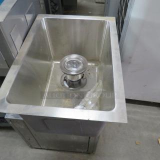 New stainless steel drop-in sink, 12x15x9.5 inches, with visible drain assembly, in excellent unused condition.