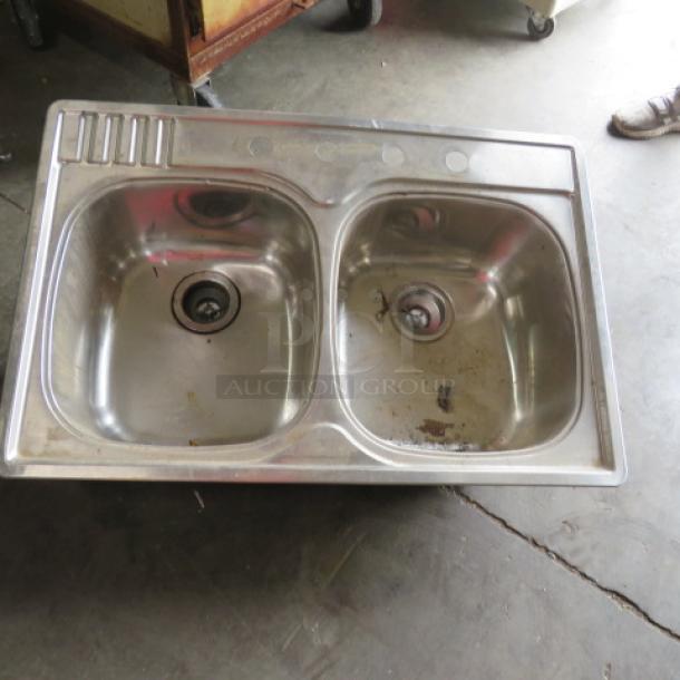 Stainless steel drop-in sink, two compartments, 33x22 inches, new condition.