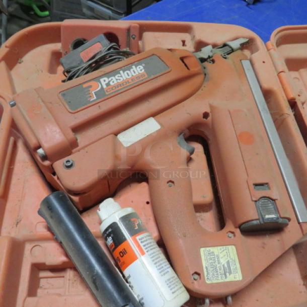 Paslode cordless 30-degree framing nailer in a carrying case, includes fastener strip and lubricating oil; used condition.