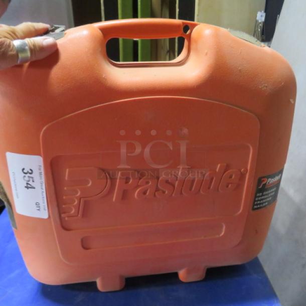 Paslode cordless 30-degree framing nailer in orange case, labeled with model details, appears in good condition.