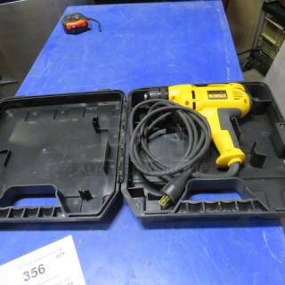 DeWalt electric drill in black case, yellow body, corded, with visible DeWalt logo, case open on blue surface.