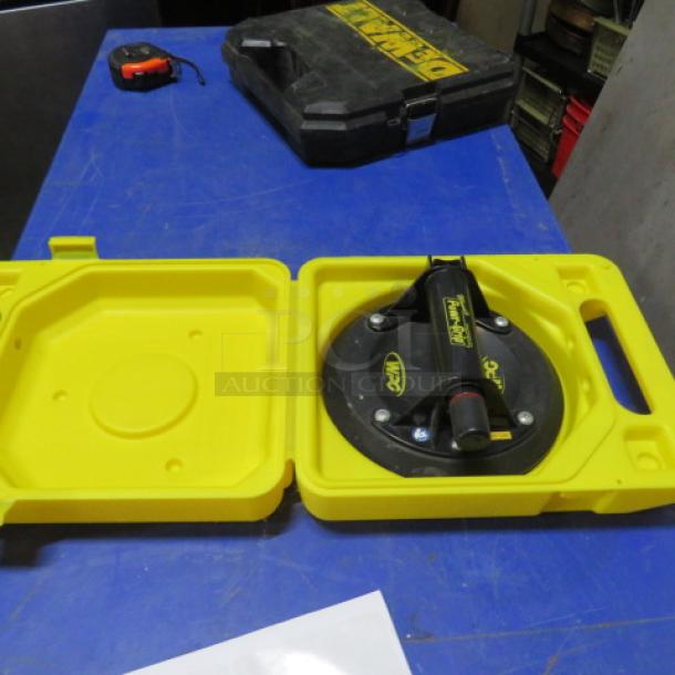 One Power Grip in yellow carry case, showcasing suction cup tool. Used condition, durable design, ideal for heavy lifting.
