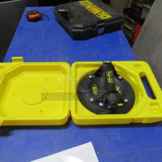 One Power Grip in yellow carry case, featuring suction mechanism for secure handling; case marked with brand logo.