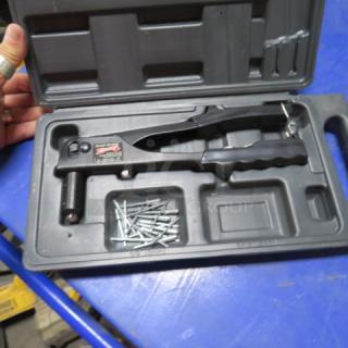 Arrow Fastener tool in black plastic case with silver fasteners included. Good condition, secure grip.