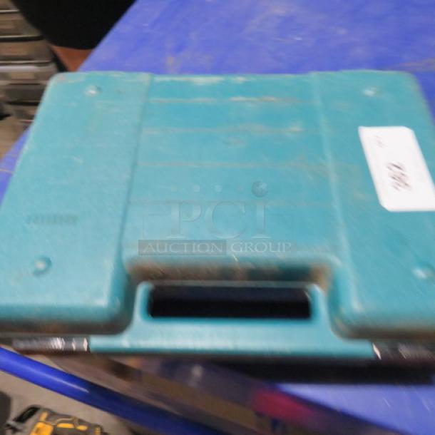 Makita cordless angle drill in teal carry case with charger, model DA391A. Case shows light wear.