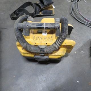 Yellow Dewalt shop vac, compact design, flex hose, signs of wear, "B.R. McMillan" written on top, used condition.