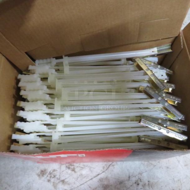 A box of new Hilti toggle bolts, neatly arranged. Bolts have metal toggles and plastic components, indicating unused condition.