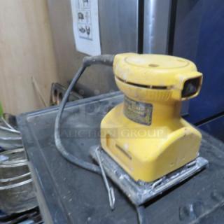 Stanley Palm Sander DW411, yellow, used condition, visible wear. Power cord attached.