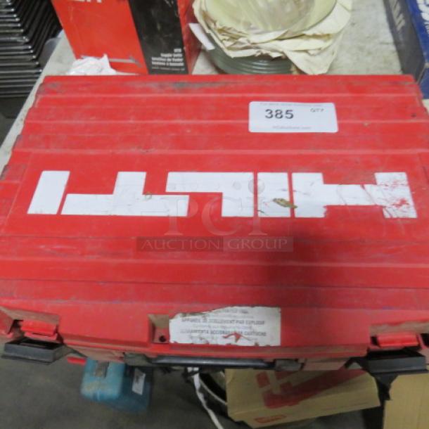 Red Hilti fastening tool carry case, model DX36M, showing scratches and wear, carries label with item number 385.
