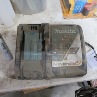 Makita DC18RC charger, well-used condition, handles Li-ion/Ni-MH 7.2-18V. Visible labels: Makita logo, model and voltage info.