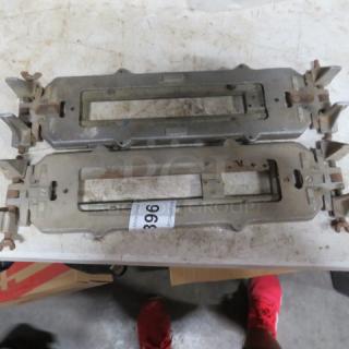 Two metal control unit brackets, slightly worn. Auction tag with number 396 attached.